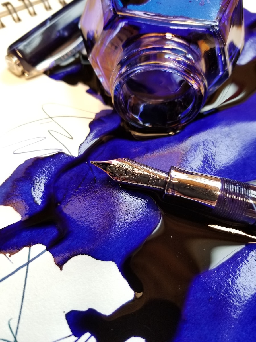 close up photo of spoiled blue ink with fountain pen